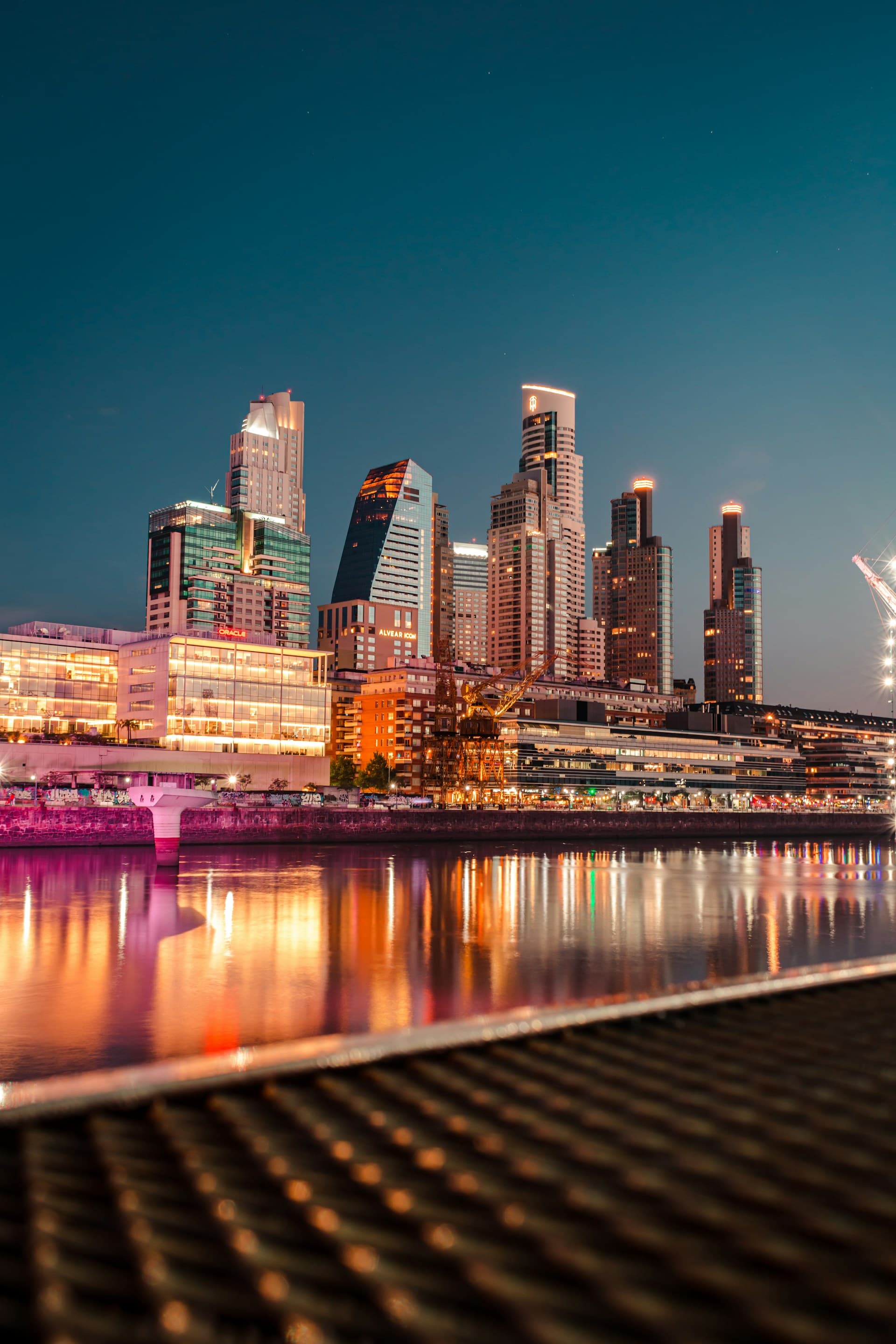 Puerto Madero's towers lit up over the water in Buenos Aires