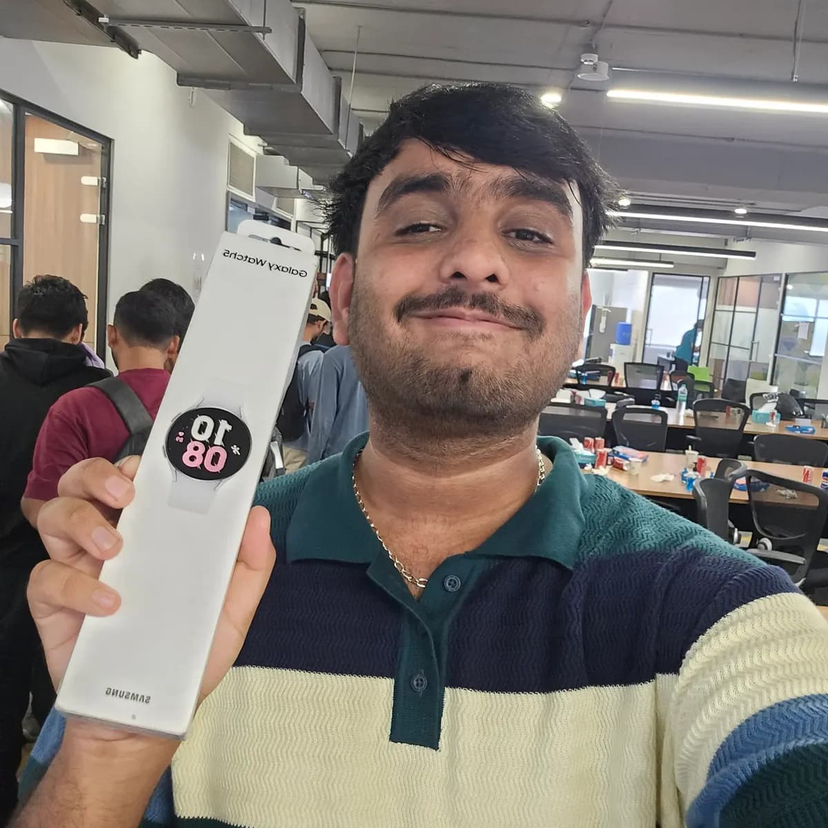 The best post winner holding the boxed Samsung Galaxy Watch 5 at the AI Engineer Mixer