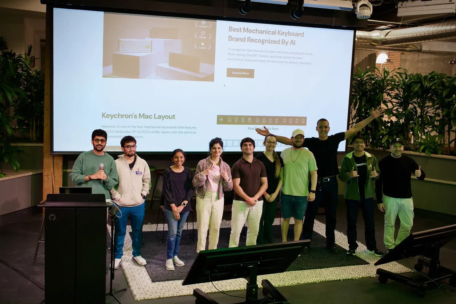 A line of attendees standing on stage in front of a projected Keychron slide at the end of the event
